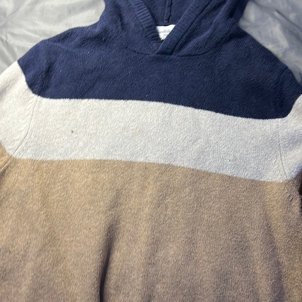blue, white, and tan hoodie
